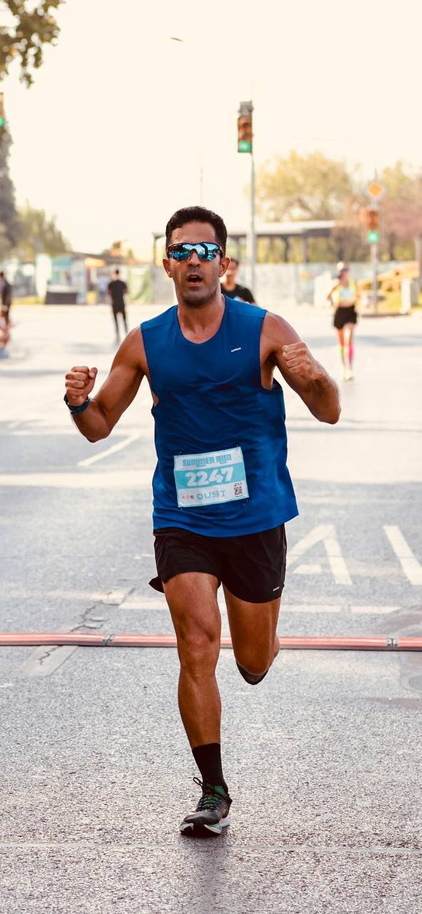 Zavosh running toward the finish on a city road