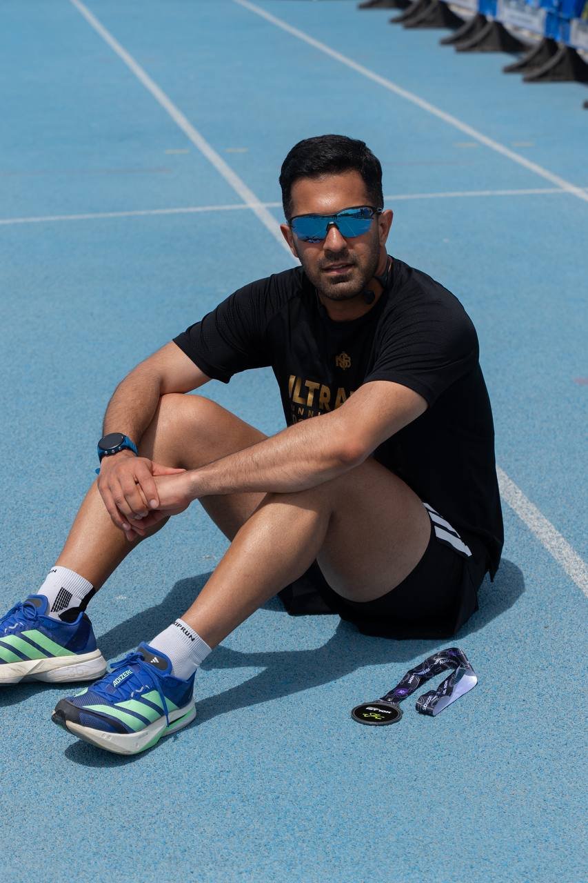 Zavosh seated on the running track after training