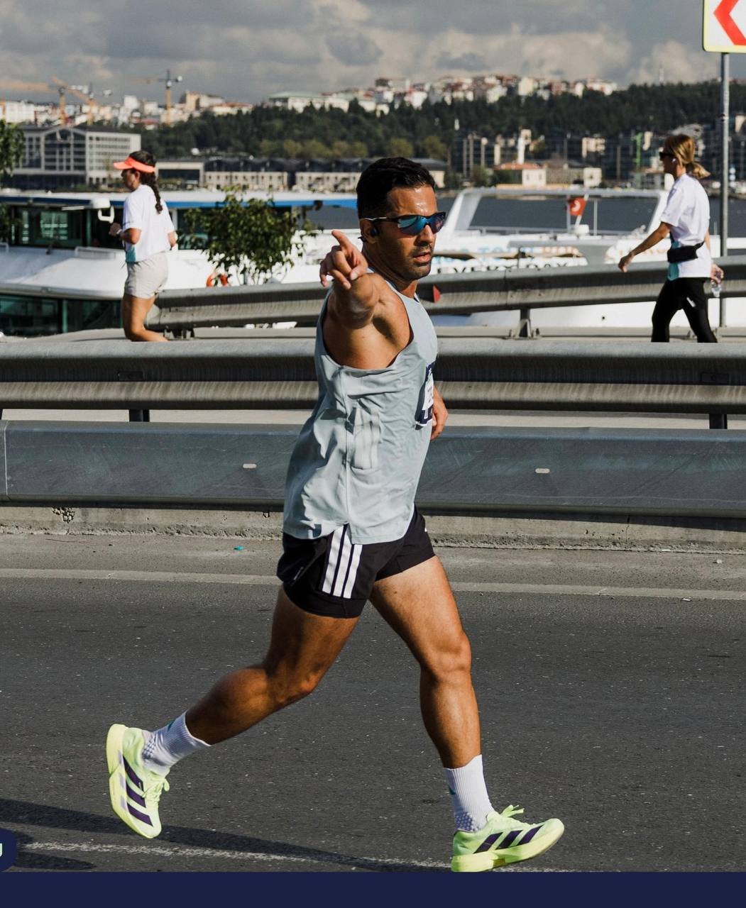 Zavosh running on a city road beside the water